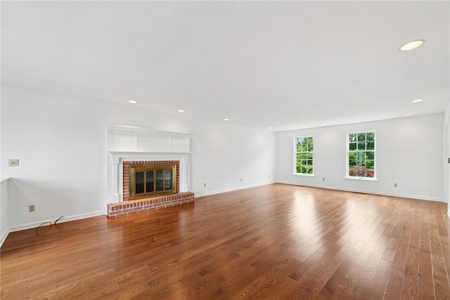 616 Edwards, Derry Twp, PA 15650 - unfurnished living room featuring wood finished floors, a brick fireplace, and recessed lighting