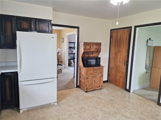 169 Fergus Rd, Slippery Rock Twp But, PA 16057 - kitchen featuring freestanding refrigerator, black microwave, light carpet, ceiling fan, and dark cabinetry