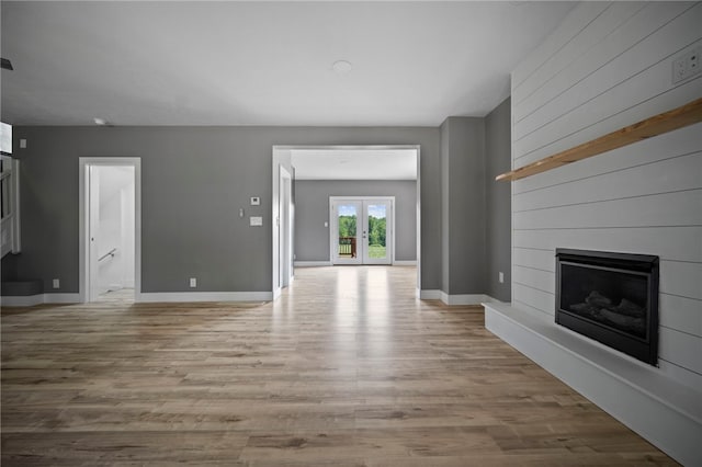736 Shenango Stop Rd, Shenango Twp Law, PA 16101 - unfurnished living room featuring a large fireplace, light wood-style floors, and french doors