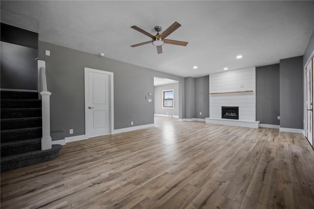 736 Shenango Stop Rd, Shenango Twp Law, PA 16101 - unfurnished living room with a ceiling fan, wood finished floors, stairway, recessed lighting, and a fireplace