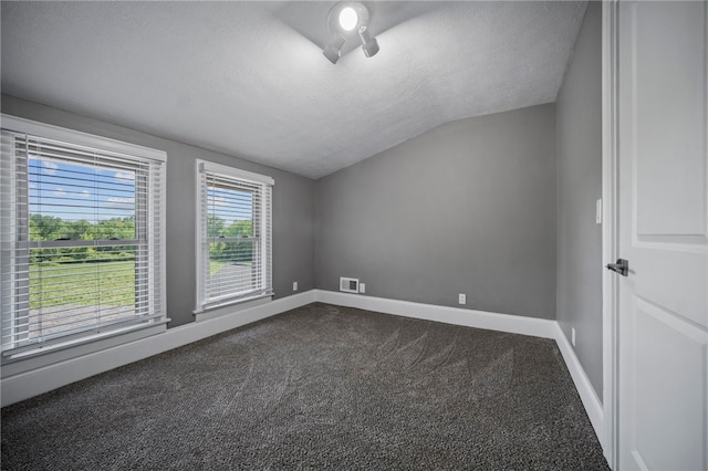 736 Shenango Stop Rd, Shenango Twp Law, PA 16101 - empty room featuring lofted ceiling, dark colored carpet, and a textured ceiling