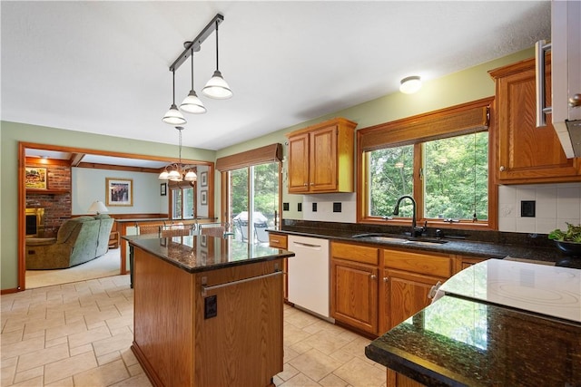 10174 Woodbury Dr, Mccandless, PA 15090 - kitchen featuring dishwasher, a center island, hanging light fixtures, a fireplace, and a chandelier