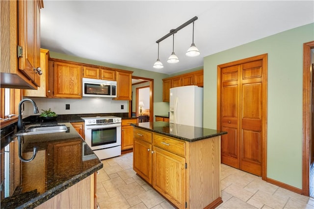 10174 Woodbury Dr, Mccandless, PA 15090 - kitchen featuring white appliances, a center island, dark stone countertops, pendant lighting, and brown cabinets