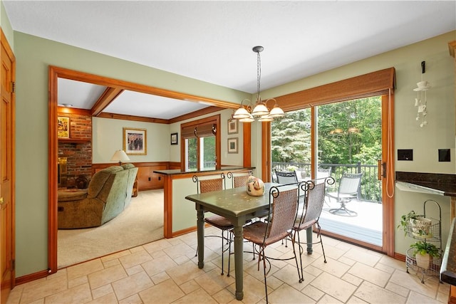 10174 Woodbury Dr, Mccandless, PA 15090 - dining area with healthy amount of natural light, a chandelier, light stone finish floors, beamed ceiling, and light colored carpet