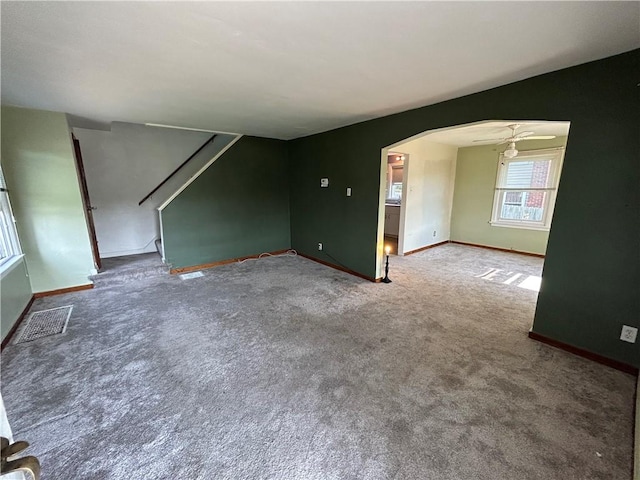 511 Oakhurst Ave N, Versailles, PA 15137 - empty room with carpet, arched walkways, and stairs
