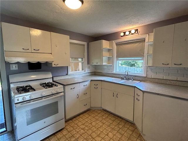 511 Oakhurst Ave N, Versailles, PA 15137 - kitchen featuring white gas stove, open shelves, under cabinet range hood, a textured ceiling, and white cabinets