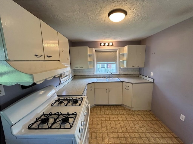 511 Oakhurst Ave N, Versailles, PA 15137 - kitchen with white gas stove, light floors, a textured ceiling, light countertops, and open shelves