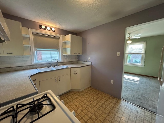 511 Oakhurst Ave N, Versailles, PA 15137 - kitchen with open shelves, a textured ceiling, light carpet, light countertops, and decorative backsplash