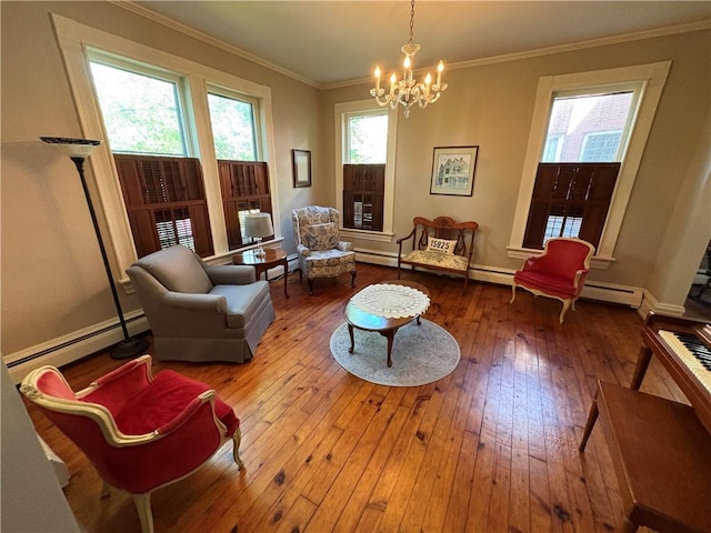 304 Jefferson St, Brookville Area School District, PA 15825 - sitting room featuring a baseboard heating unit, wood-type flooring, a chandelier, and crown molding