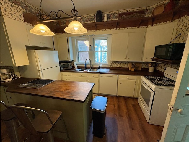 304 Jefferson St, Brookville Area School District, PA 15825 - kitchen with white appliances, dark wood-style floors, a peninsula, white cabinetry, and wooden counters