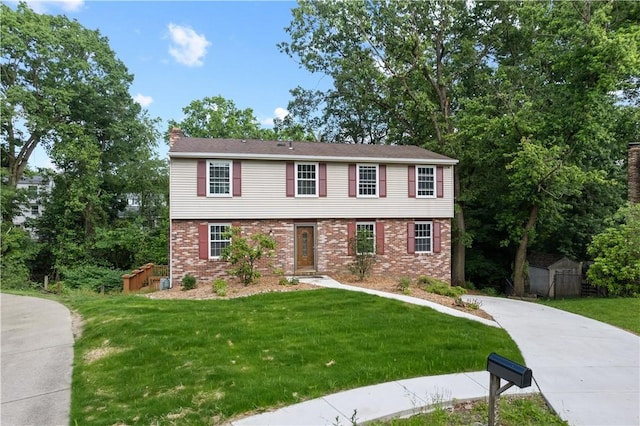 320 Penn Lear Ct, Monroeville, PA 15146 - colonial-style house featuring brick siding, a front yard, a chimney, and concrete driveway