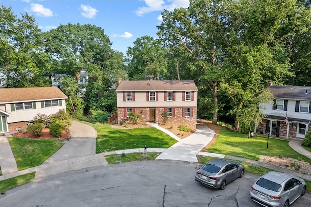 320 Penn Lear Ct, Monroeville, PA 15146 - view of front of property with a front yard, brick siding, and view of scattered trees