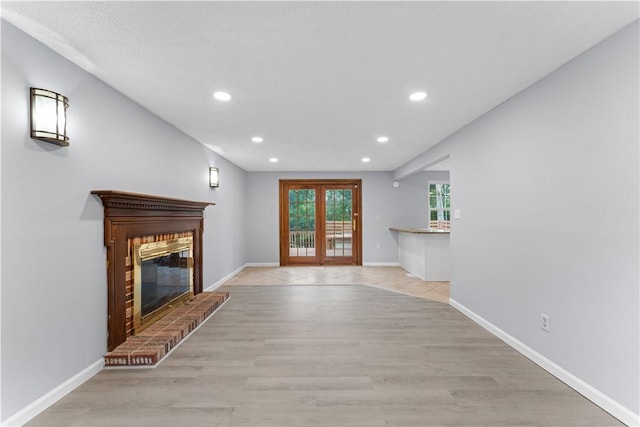 320 Penn Lear Ct, Monroeville, PA 15146 - unfurnished living room featuring recessed lighting, light wood finished floors, a fireplace, and french doors