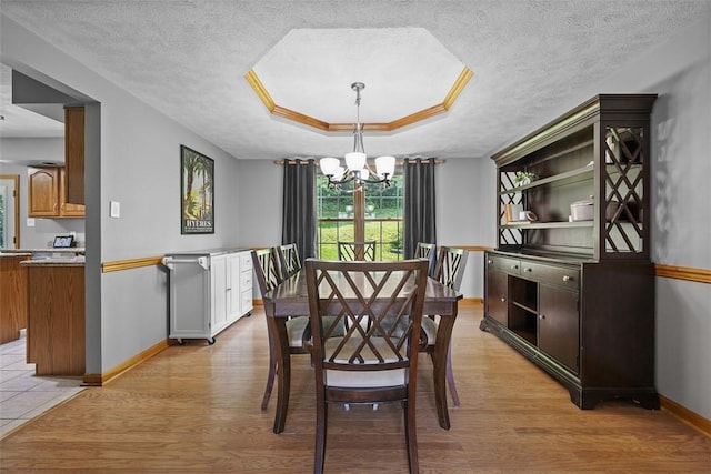 3004 Woodfield Dr, Hopewell Twp Bea, PA 15001 - dining area featuring a chandelier, light wood finished floors, a tray ceiling, and a textured ceiling