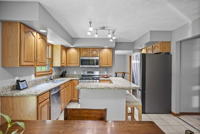 3004 Woodfield Dr, Hopewell Twp Bea, PA 15001 - kitchen with stainless steel appliances, light tile patterned floors, light stone countertops, and a kitchen island
