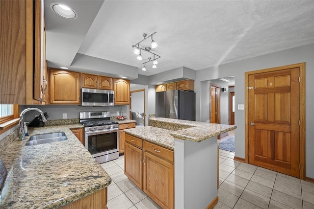 3004 Woodfield Dr, Hopewell Twp Bea, PA 15001 - kitchen featuring appliances with stainless steel finishes, light tile patterned flooring, light stone counters, a center island, and brown cabinets