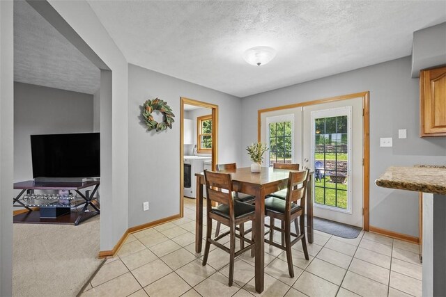 3004 Woodfield Dr, Hopewell Twp Bea, PA 15001 - dining room with washer / clothes dryer, a textured ceiling, light tile patterned flooring, and french doors