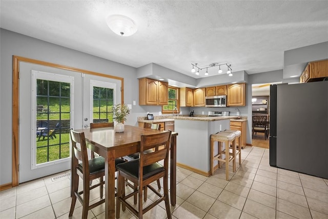 3004 Woodfield Dr, Hopewell Twp Bea, PA 15001 - dining space featuring light tile patterned floors, healthy amount of natural light, and a textured ceiling