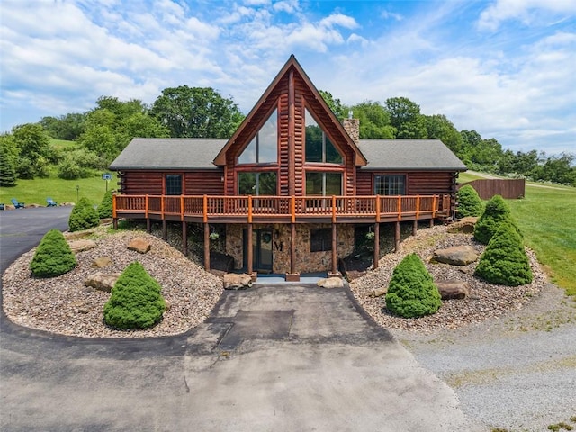 1155 Sarver Rd, South Buffalo Twp, PA 16055 - rear view of property featuring log exterior, a deck, driveway, and a chimney