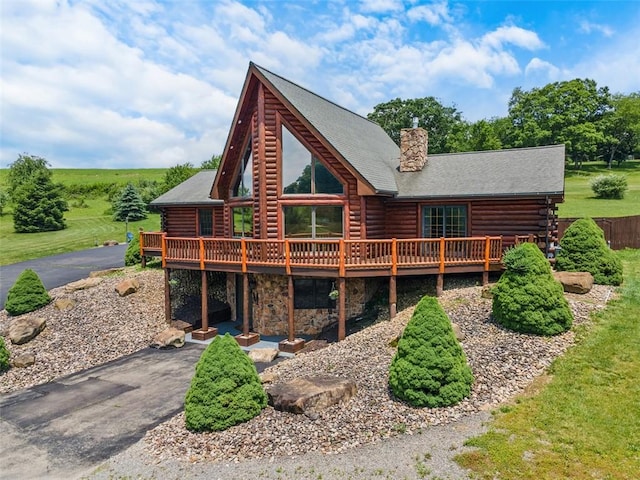 1155 Sarver Rd, South Buffalo Twp, PA 16055 - view of front facade with a deck, log siding, a chimney, driveway, and stone siding