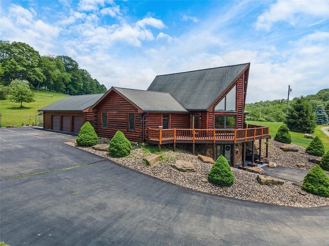 1155 Sarver Rd, South Buffalo Twp, PA 16055 - log cabin featuring a deck, stone siding, a detached garage, and log siding
