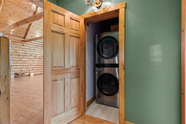 1155 Sarver Rd, South Buffalo Twp, PA 16055 - laundry area featuring stacked washer / drying machine, log walls, wood finished floors, and wood ceiling