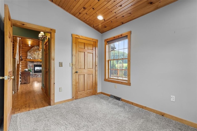 1155 Sarver Rd, South Buffalo Twp, PA 16055 - unfurnished bedroom with wooden ceiling, carpet floors, vaulted ceiling, a fireplace, and log walls