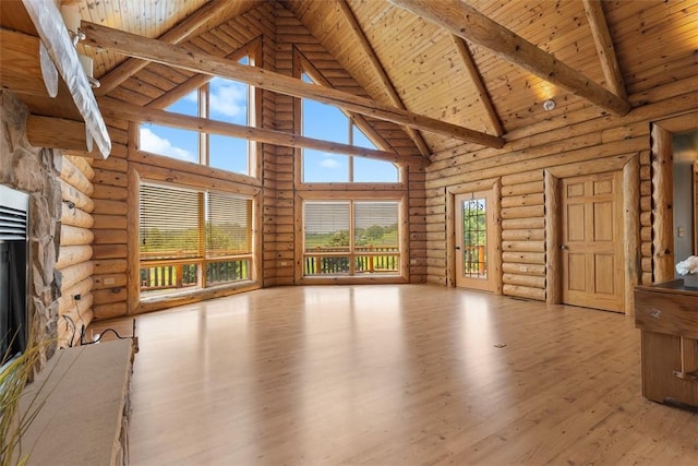 1155 Sarver Rd, South Buffalo Twp, PA 16055 - unfurnished living room featuring high vaulted ceiling, a wood ceiling with exposed beams, log walls, wood finished floors, and a stone fireplace