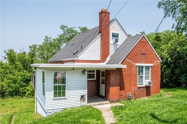 819 Toman Ave, Clairton, PA 15025 - view of front of home featuring a front lawn, a chimney, brick siding, and cooling unit