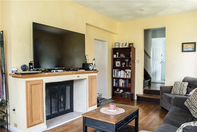 819 Toman Ave, Clairton, PA 15025 - living room with wood finished floors, stairs, and a glass covered fireplace