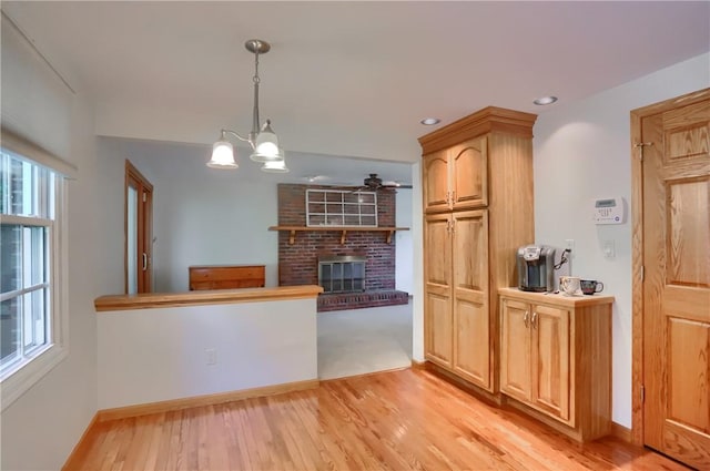 217 Baintree Rd, Moon/Crescent Twp, PA 15108 - kitchen with a brick fireplace, light wood-type flooring, a chandelier, decorative light fixtures, and recessed lighting
