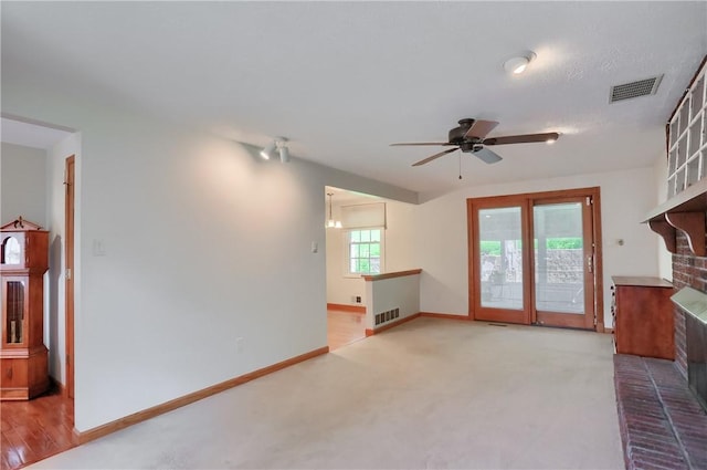 217 Baintree Rd, Moon/Crescent Twp, PA 15108 - unfurnished living room with a brick fireplace, a ceiling fan, and carpet
