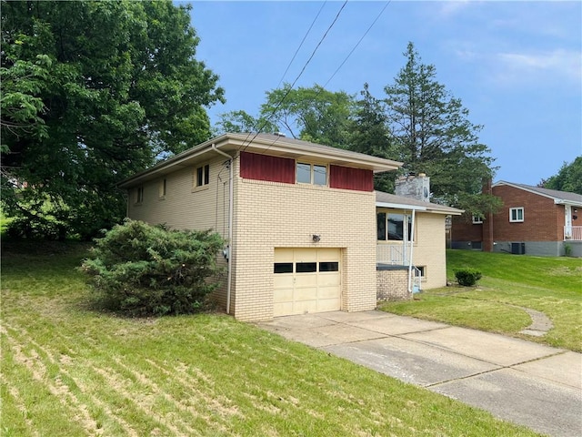 131 Monica Dr, Hempfield Twp Wml, PA 15601 - view of side of home with brick siding, a garage, concrete driveway, and a yard
