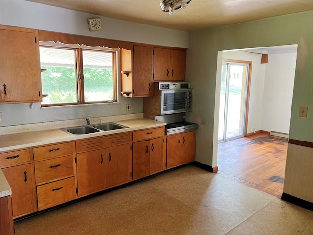 131 Monica Dr, Hempfield Twp Wml, PA 15601 - kitchen featuring light countertops, light flooring, healthy amount of natural light, and brown cabinetry