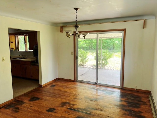 131 Monica Dr, Hempfield Twp Wml, PA 15601 - unfurnished dining area featuring a chandelier, wood finished floors, and a baseboard heating unit