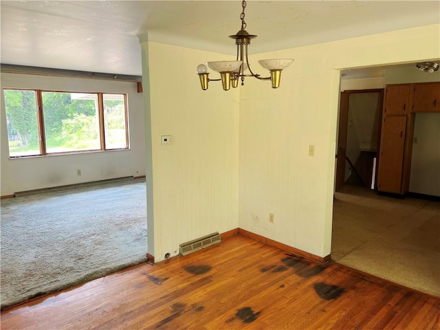 131 Monica Dr, Hempfield Twp Wml, PA 15601 - unfurnished dining area with a chandelier and wood finished floors