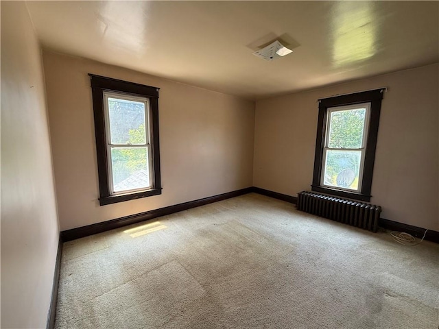 102 Bayard Ave, Dry Tav/Rices Landing, PA 15357 - spare room featuring radiator heating unit, plenty of natural light, and light colored carpet