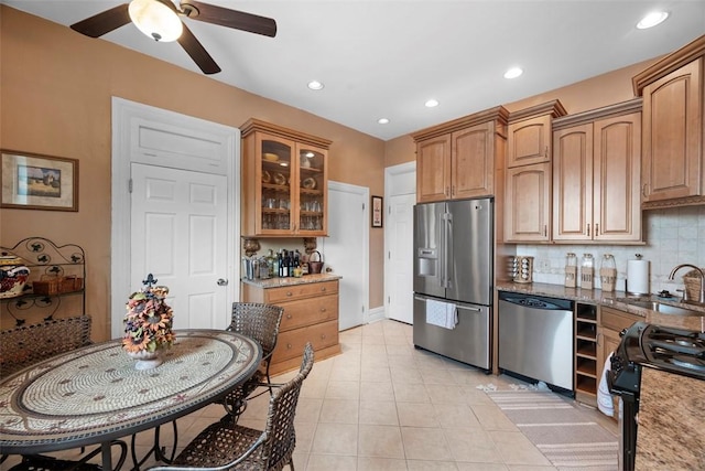 813 S Braddock Ave Unit 5, Regent Square, PA 15221 - kitchen with appliances with stainless steel finishes, a ceiling fan, glass insert cabinets, tasteful backsplash, and light tile patterned flooring