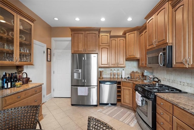 813 S Braddock Ave Unit 5, Regent Square, PA 15221 - kitchen featuring appliances with stainless steel finishes, stone countertops, tasteful backsplash, glass insert cabinets, and recessed lighting
