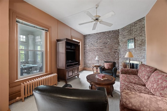 813 S Braddock Ave Unit 5, Regent Square, PA 15221 - living area with radiator, brick wall, a ceiling fan, and light colored carpet