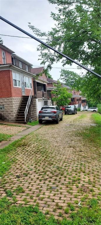 2517 S Braddock Ave, Swissvale, PA 15218 - view of front of house featuring stairway and brick siding