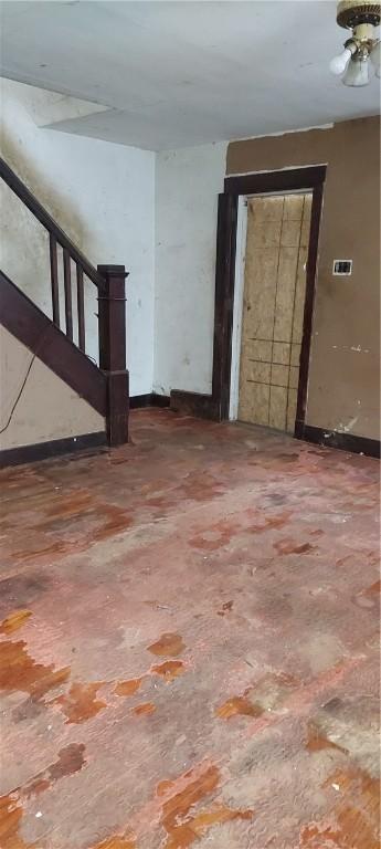 2517 S Braddock Ave, Swissvale, PA 15218 - unfurnished living room with stairs and baseboards