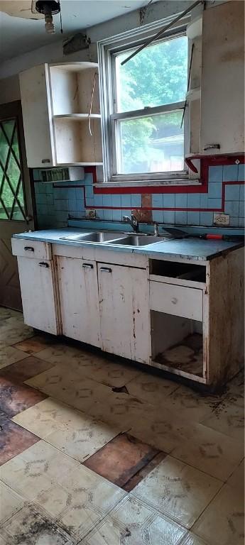 2517 S Braddock Ave, Swissvale, PA 15218 - kitchen featuring white cabinetry, decorative backsplash, open shelves, and light floors