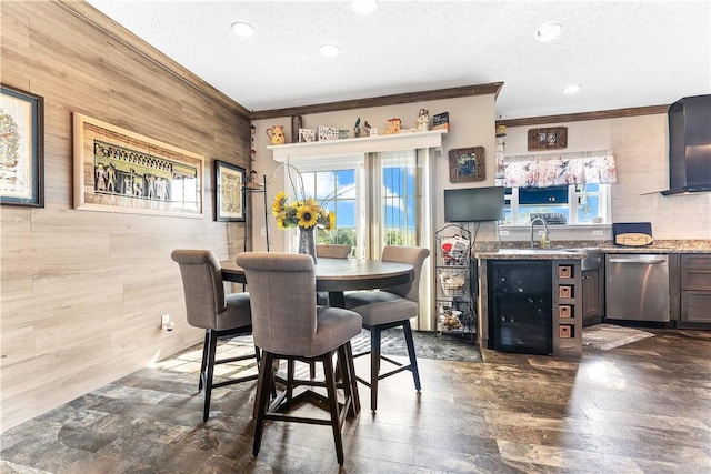 140 Jocelynn Ln, Smithfield, PA 15478 - dining room with beverage cooler, crown molding, recessed lighting, a textured ceiling, and wooden walls