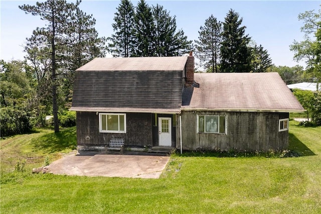 4731 National Pike, Wharton Twp, PA 15459 - colonial inspired home with a front lawn, a chimney, and a patio area