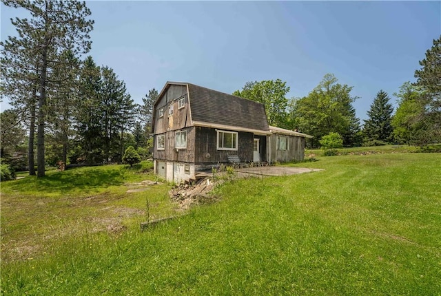 4731 National Pike, Wharton Twp, PA 15459 - view of side of home with a gambrel roof, a lawn, and a garage