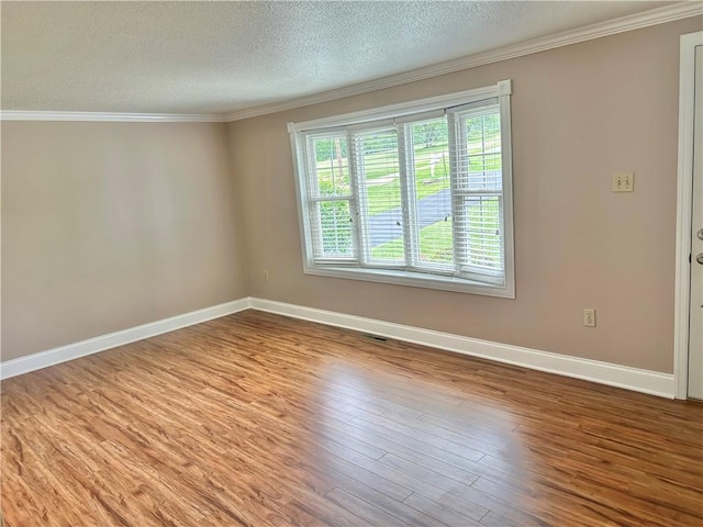 71 Armstrong Dr, Canton Twp, PA 15301 - spare room featuring a textured ceiling, ornamental molding, and wood finished floors