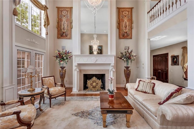 7023 Fair Oaks Dr, Export, PA 15632 - living room featuring a towering ceiling, a chandelier, wood finished floors, and a fireplace with flush hearth