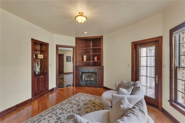 7023 Fair Oaks Dr, Export, PA 15632 - living area featuring a fireplace, wood finished floors, and built in shelves
