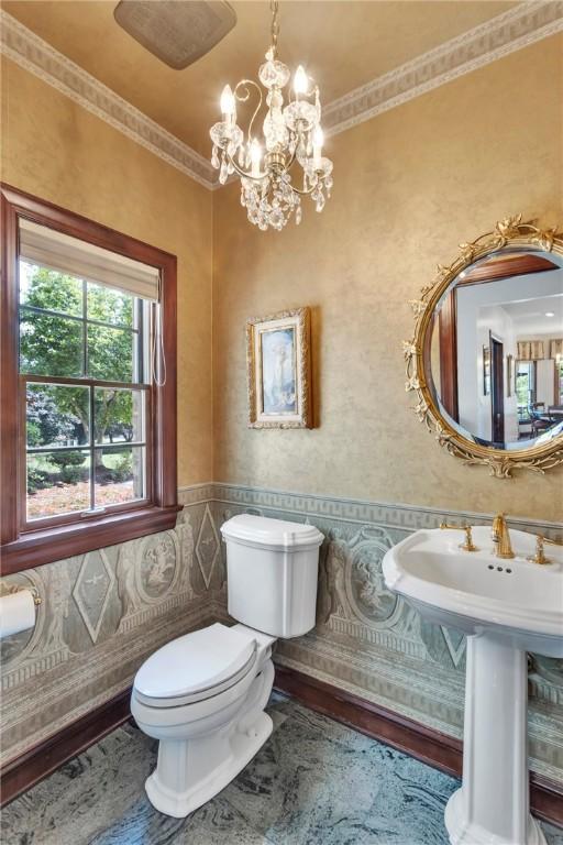 7023 Fair Oaks Dr, Export, PA 15632 - half bath with a chandelier, wainscoting, wallpapered walls, and crown molding